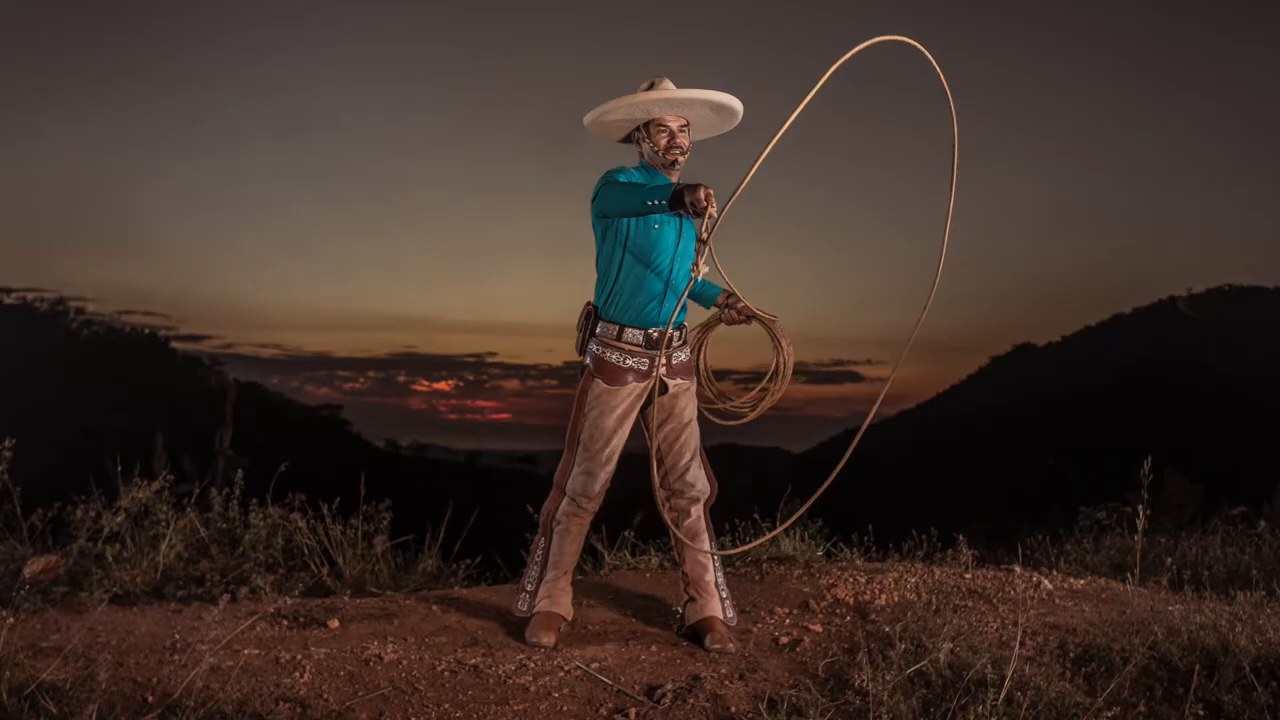 Charro spinning a lasso at sunset near Compostela, Mexico