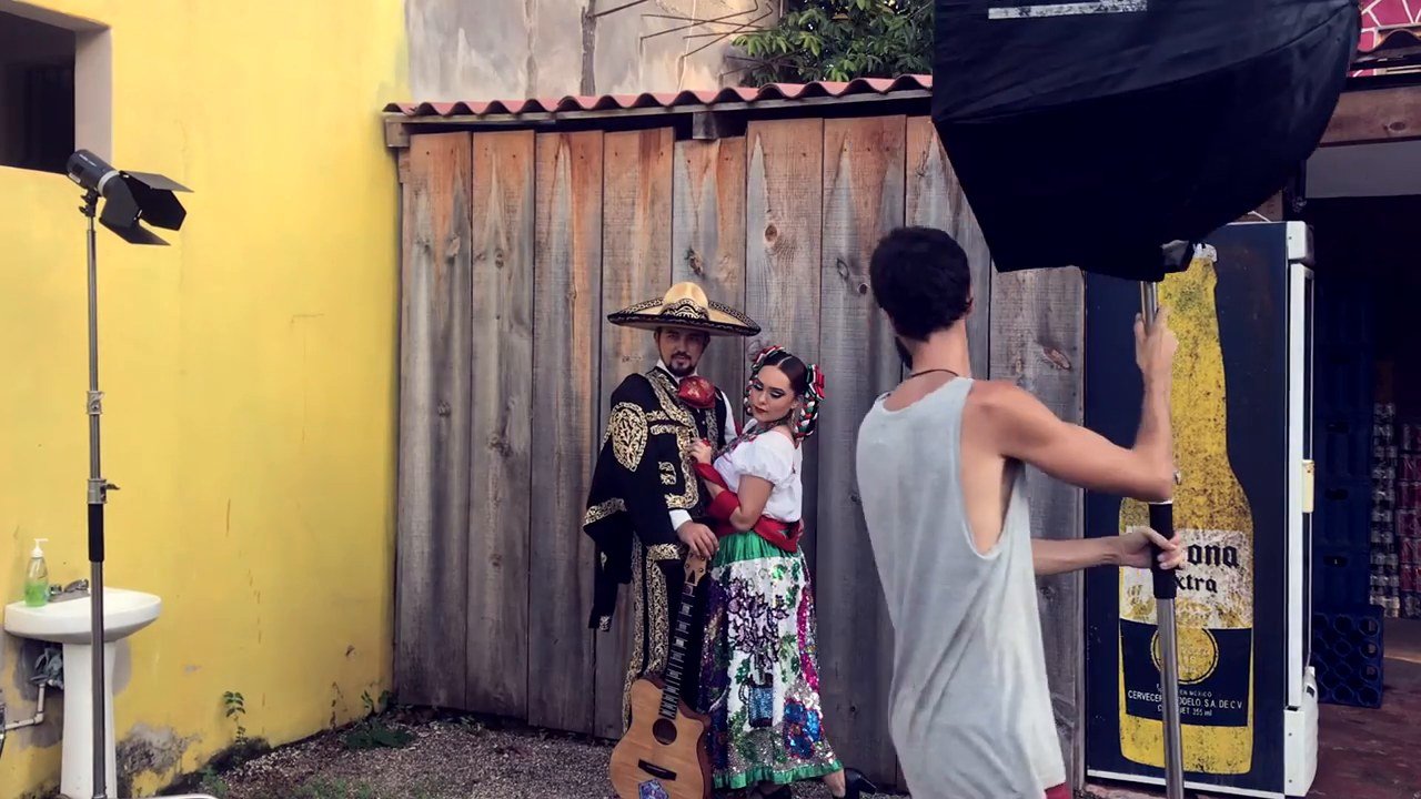 Photographer with a camera photographing a charro and a folklorico dancer by a softbox in Sayulita, Nayarit
