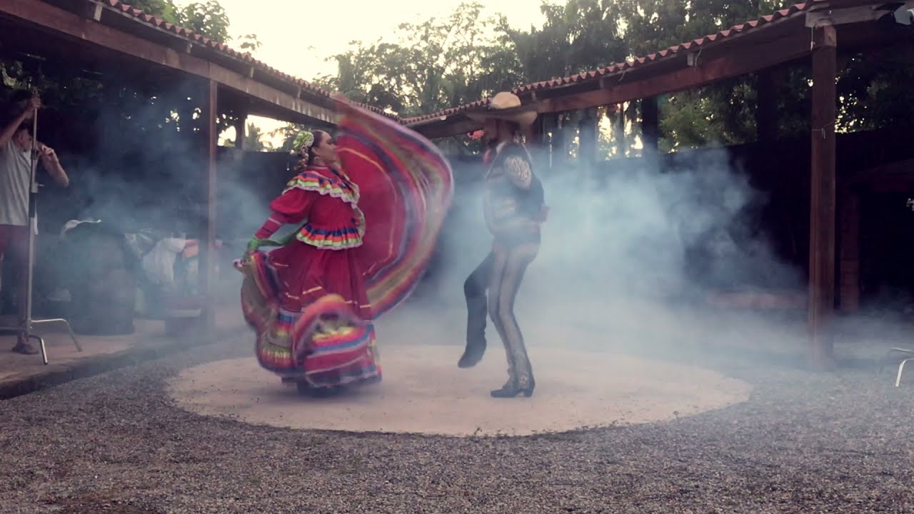 Folklorico dancers in a China Poblana dress and charro suit on set inside a tequila distillery in Sayulita, Mexico